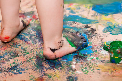 Little girl walking barefoot on fresh paint