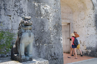 Woman wearing mask against wall