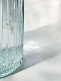 Close-up of glass on table against sea