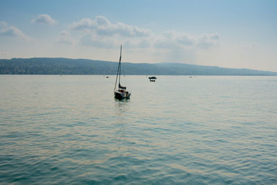 Sailboat in sea against sky