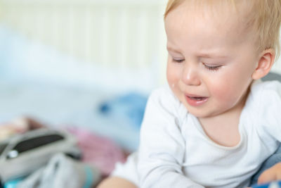 Cute baby boy crying at home