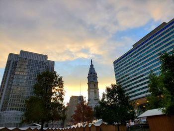 Low angle view of modern buildings against sky during sunset