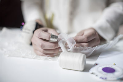 Wedding dress designer working, needlework