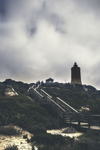 View of castle on mountain against cloudy sky