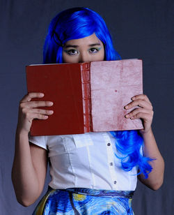 Portrait of a young woman holding book