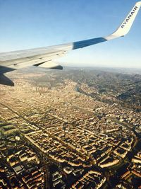 Aerial view of city by sea against sky