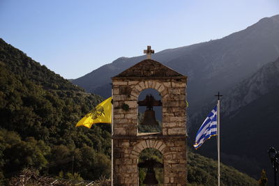 View of bell tower and mountain against sky