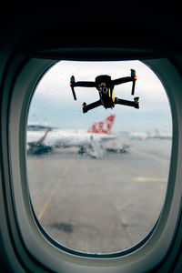 Man seen through airplane window