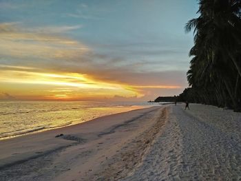 Scenic view of beach against sky during sunset