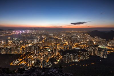 High angle view of city lit up at night