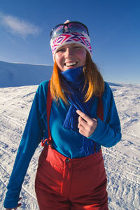 Close up joyful young woman on snowy mountain portrait picture