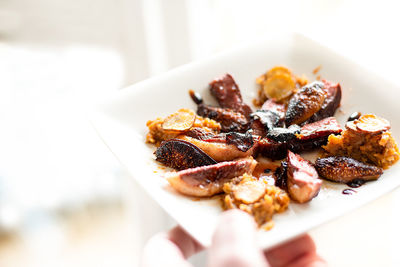 Close-up of hand holding food on table