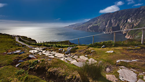 Scenic view of sea and mountains against sky