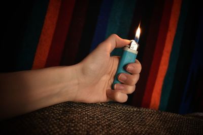 Close-up of hand holding candle