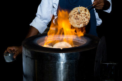 Midsection of man preparing food