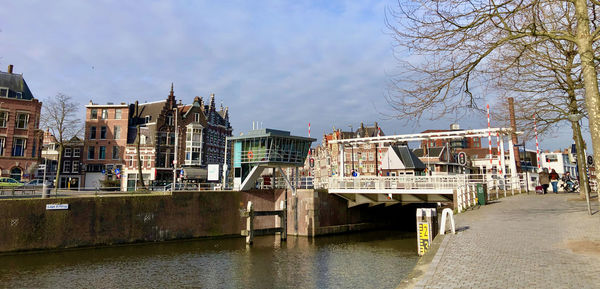 River amidst buildings against sky in city