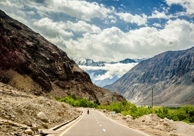 Road amidst mountains against sky