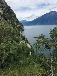 Scenic view of sea and mountains against sky