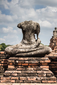 Statue of buddha against cloudy sky