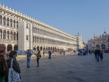 People at town square against clear sky