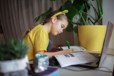 Cute girl doing homework at home