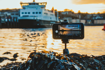 Smart phone photography setup capturing an island sunset