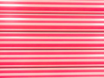 Full frame shot of pink striped blinds
