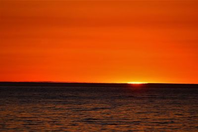 Scenic view of sea against romantic sky at sunset