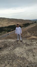 Full length of man standing on land against sky