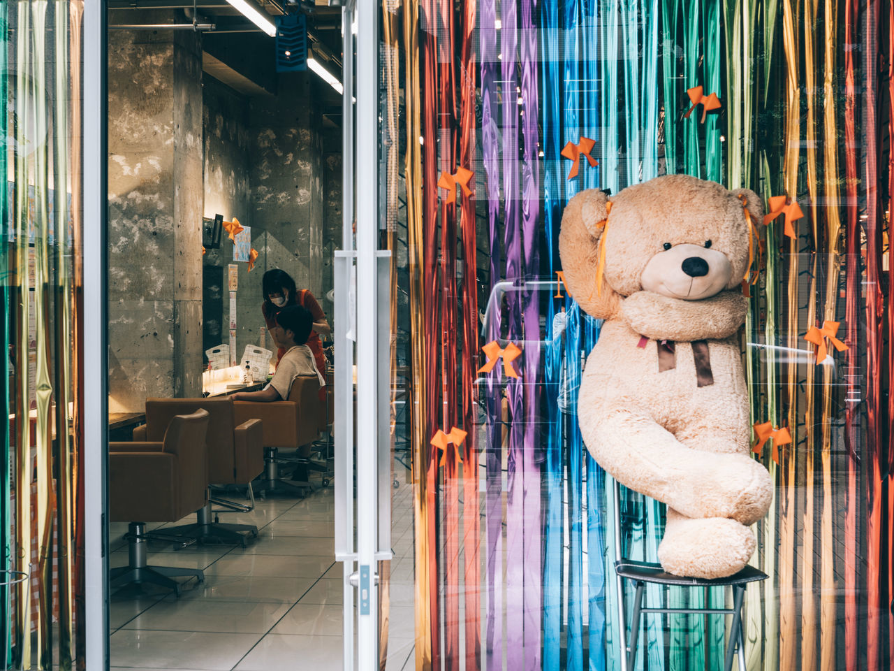 representation, toy, display window, stuffed toy, store, teddy bear, no people, animal representation, art, human representation, street, retail, blue, indoors, hanging, business, creativity, architecture, day