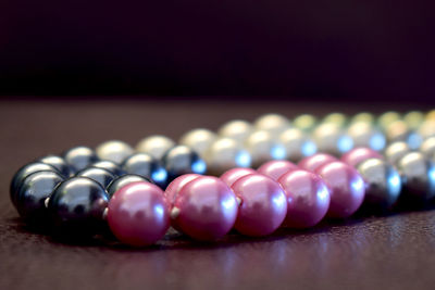 Close-up of multi colored necklace on table