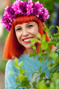 Portrait of smiling woman wearing wreath outdoors