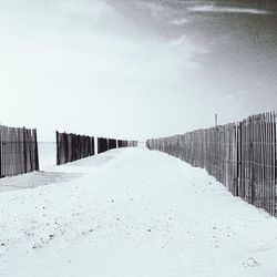 Snow covered landscape against sky