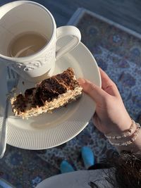 Midsection of woman holding cake