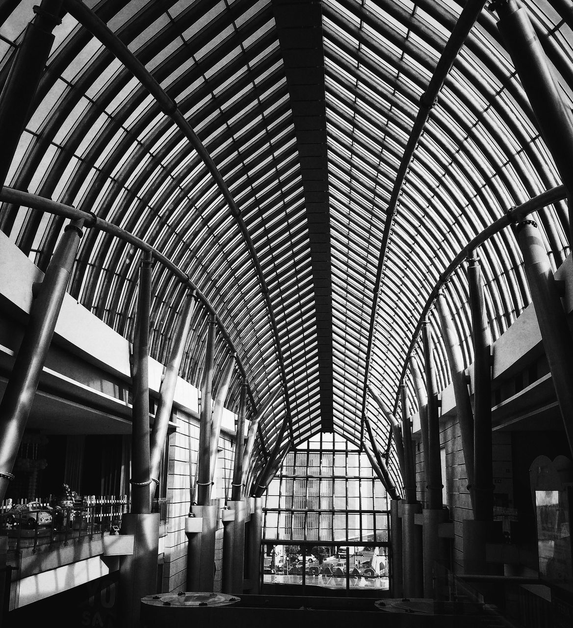 indoors, architecture, built structure, ceiling, interior, arch, low angle view, window, architectural feature, glass - material, skylight, building, pattern, architectural column, building exterior, modern, day, railing, no people, metal