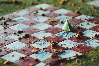 High angle view of messy tile on grass in park