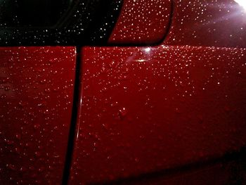 Detail shot of water drops on red surface