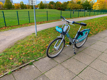 Bicycle parked on footpath in park