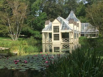 House by lake against building