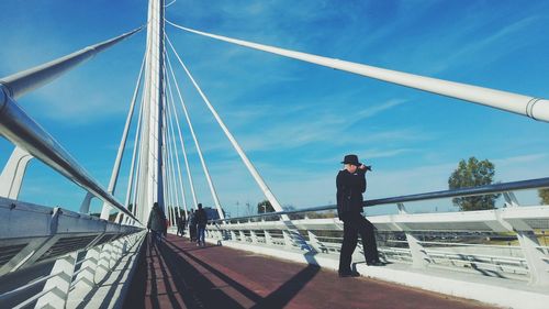 Close-up of woman against blue sky
