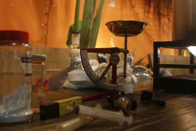 Weight scale and syringe on table at microbrewery