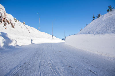Scenic view of snowcapped mountains against clear blue sky