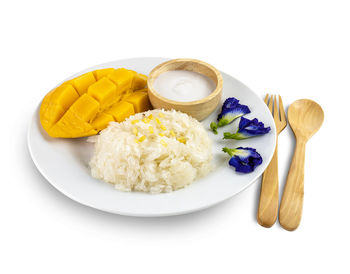 High angle view of food in plate against white background