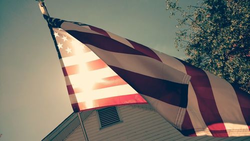 Low angle view of flag against clear sky