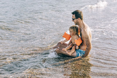 Full length of a young couple in sea