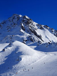 Scenic view of snowcapped mountain against clear blue sky