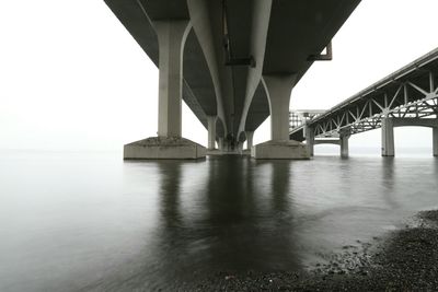 Bridges over sea against sky