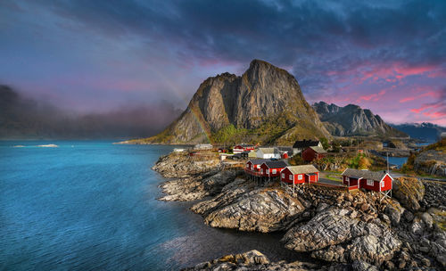 Scenic view of sea and mountains against sky