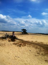 Scenic view of beach against cloudy sky