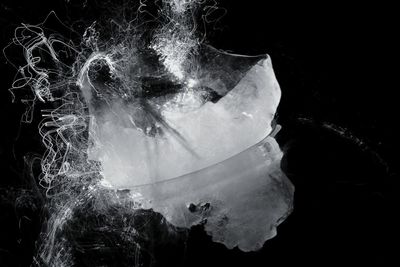 Digital composite image of jellyfish against black background